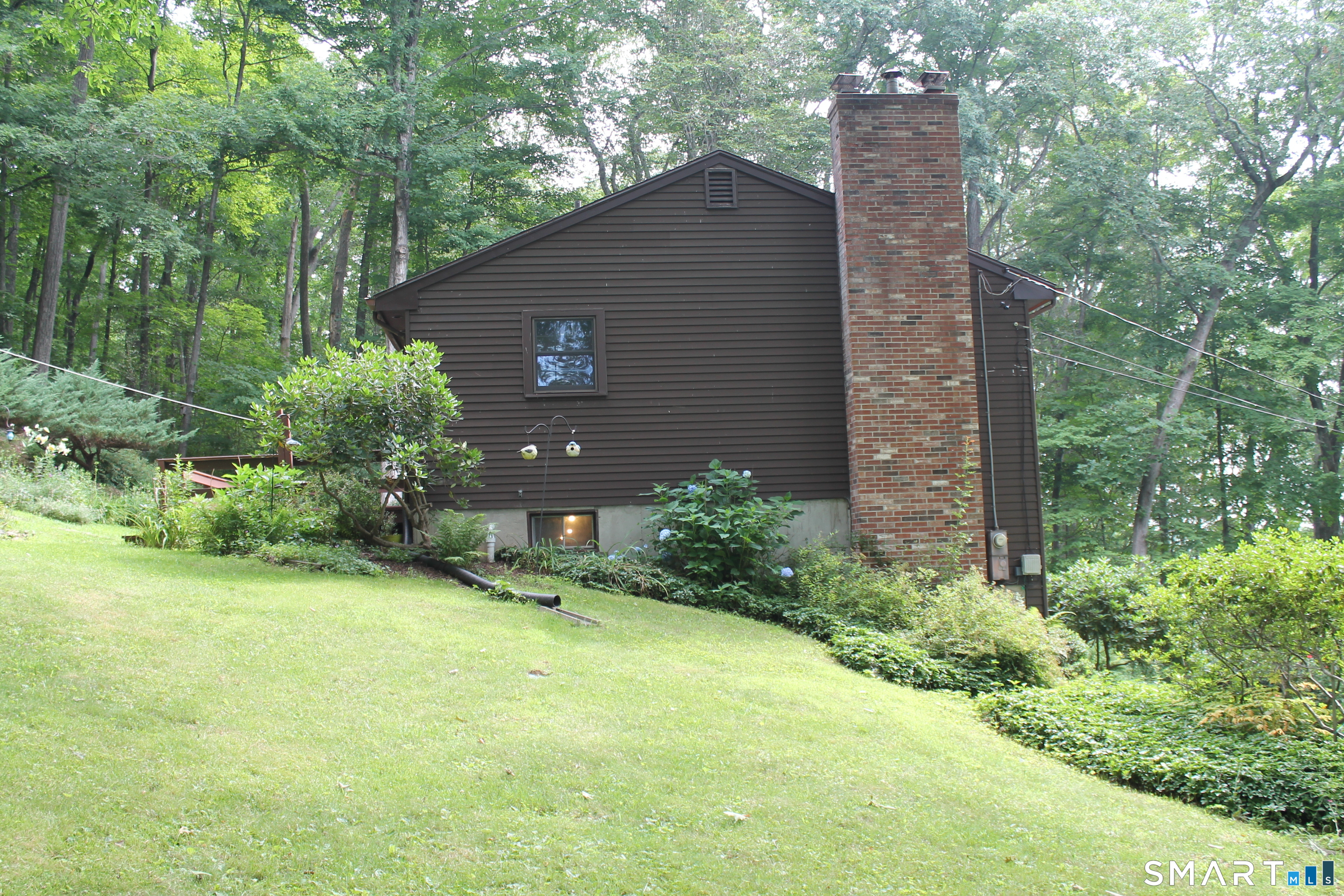 35 Pigeon Swamp Road, Unit 2 Lebanon, CT 06249 - Photo 6 of 35 a backyard of a house with plants and large tree