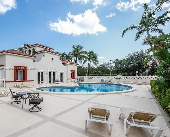 a front view of a house with a yard and fountain