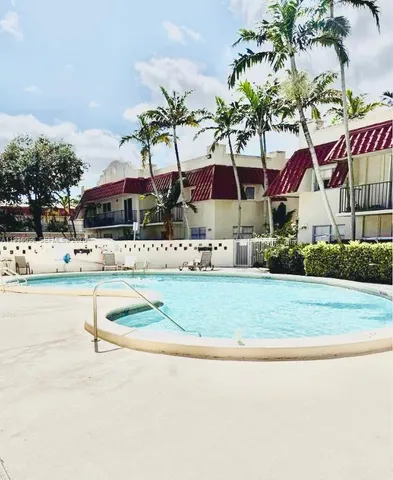 swimming pool view with a seating space