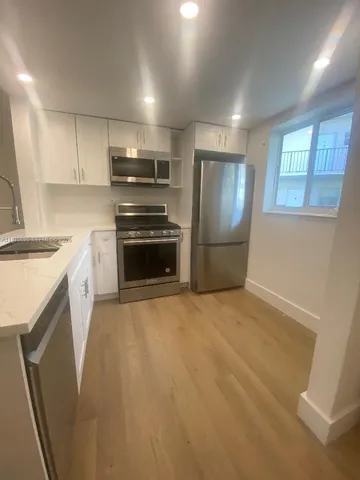 a kitchen with refrigerator and window