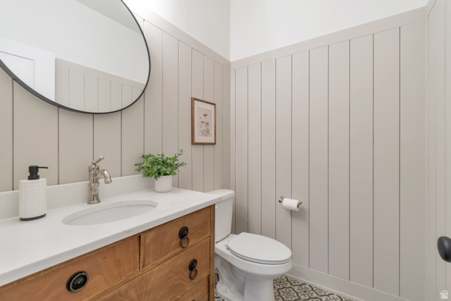 1820 West Farmhouse Flats Road Peoa, UT 84061 - Photo 35 of 79 Bathroom vanity featuring a wood-finish cabinet, white countertop, and under-mount sink with a brushed nickel faucet