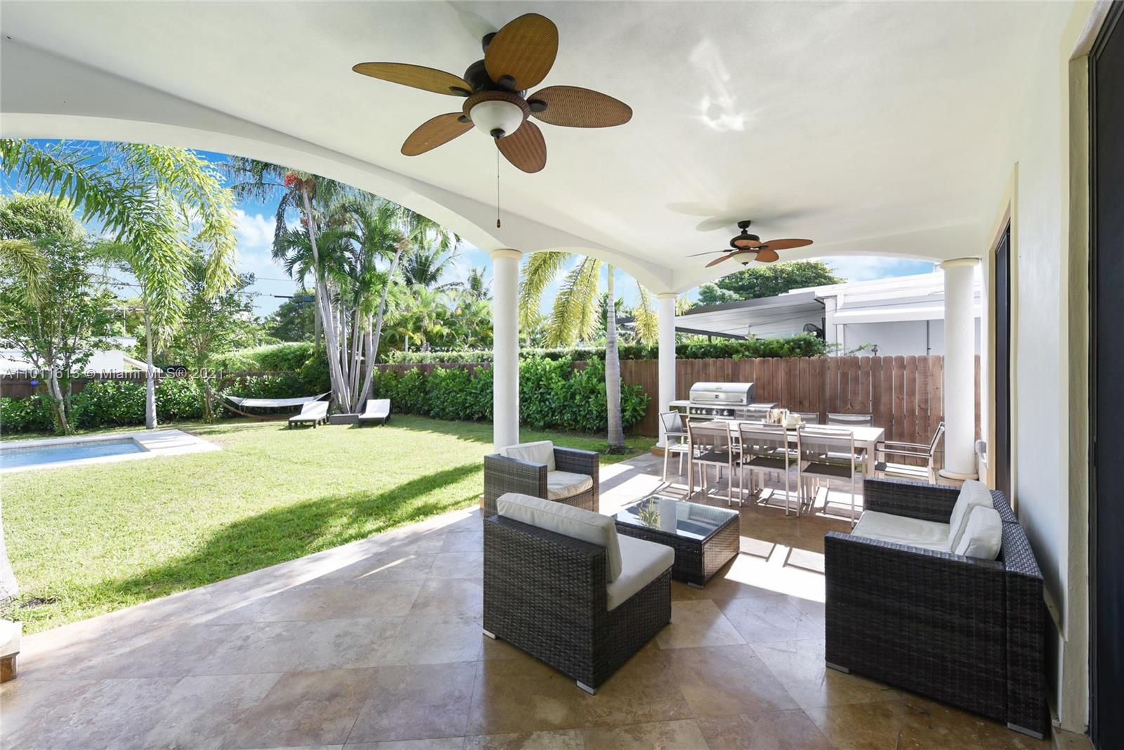 471 Southwest 30th Road Miami, FL 33129 - Photo 24 of 27 Undercover Porch Area w/ BBQ Grill | Pool | Fenced in Backyard