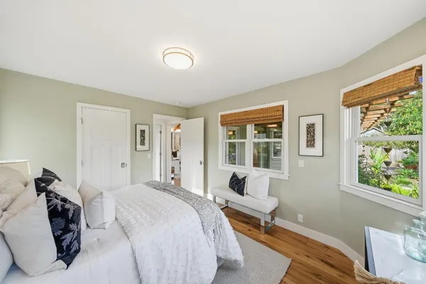 a bedroom with furniture and a large window