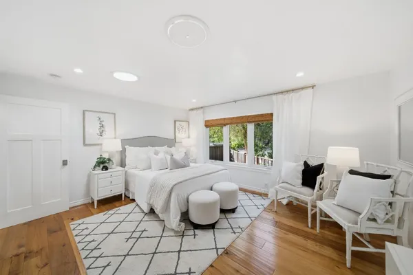 a very nice looking room with a large window and white cabinets