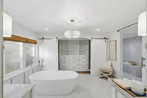 a bathroom with a window and a shower