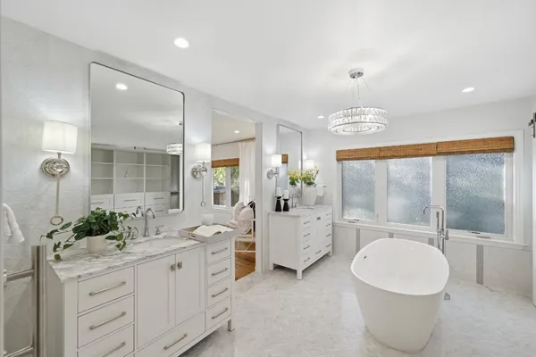 a bathroom with a sink a toilet and a window