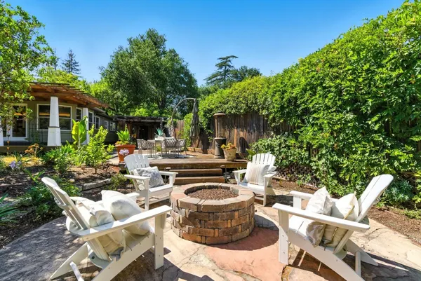 a view of a chairs and table in the patio