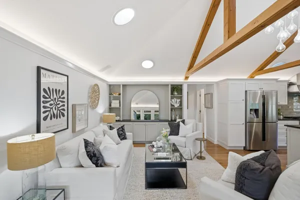 a living room with furniture and a floor to ceiling window