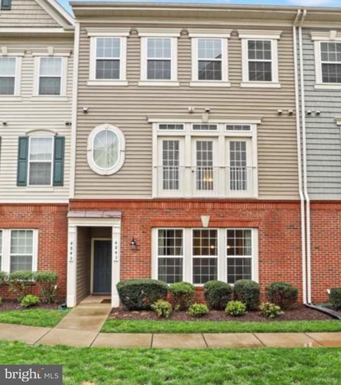 Charming townhouse with inviting curb appeal.