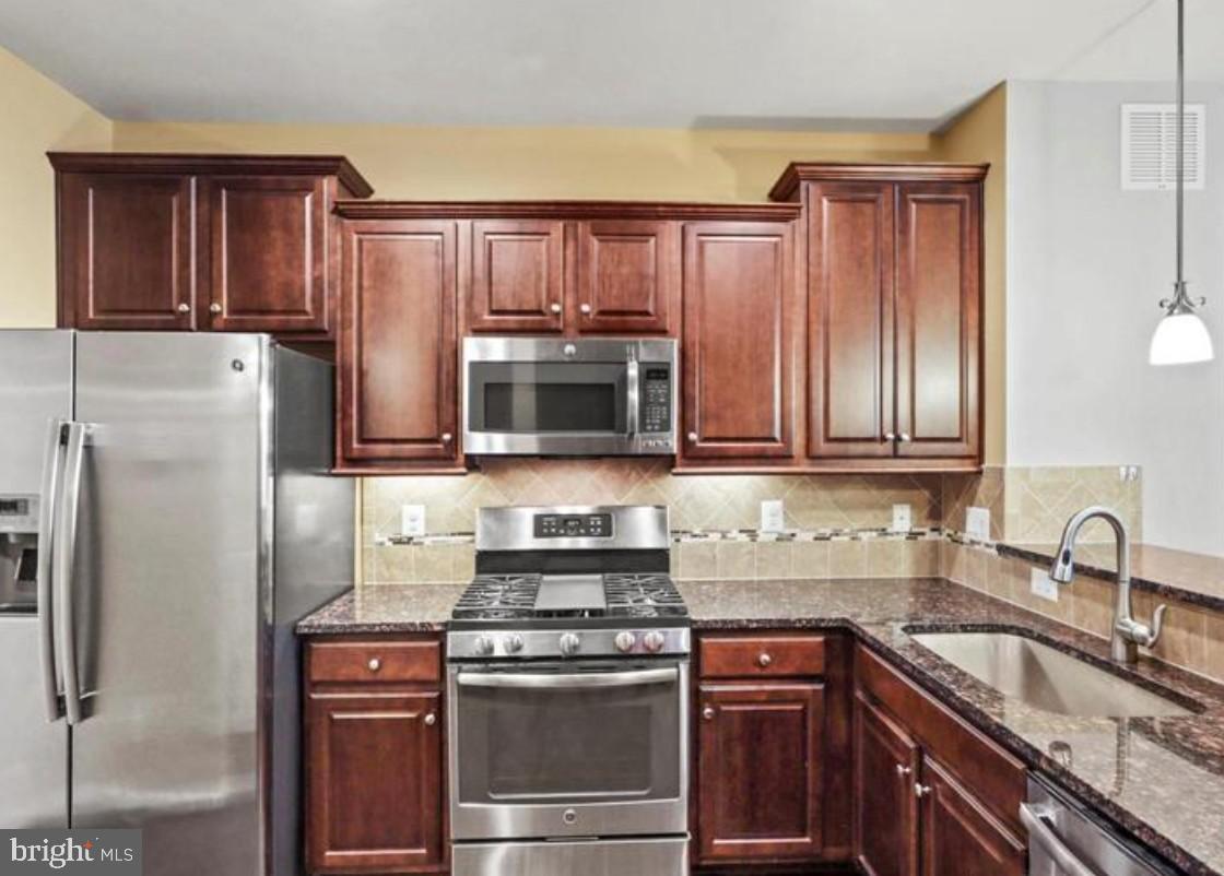 4843 Dane Ridge Circle Woodbridge, VA 22193 - Photo 4 of 24 Modern kitchen with rich wood cabinetry.