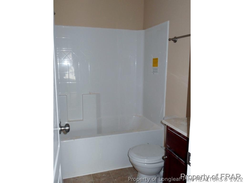 3463 Thrower Road Hope Mills, NC 28348 - Photo 17 of 24 a bathroom with a toilet and a bathtub