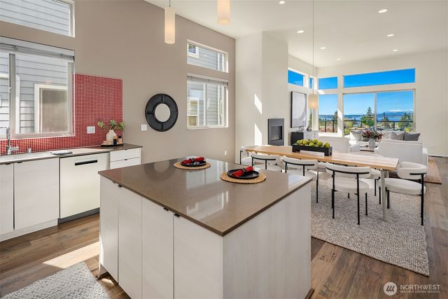 a kitchen with a stove a refrigerator and a dining table