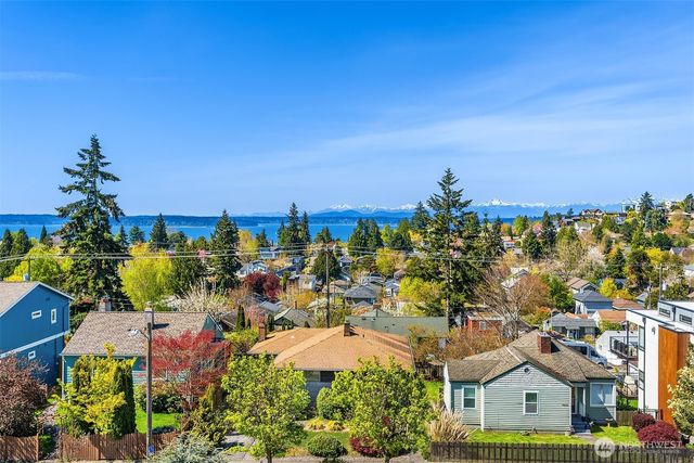 a bathroom with a double vanity sink a mirror and a bathtub