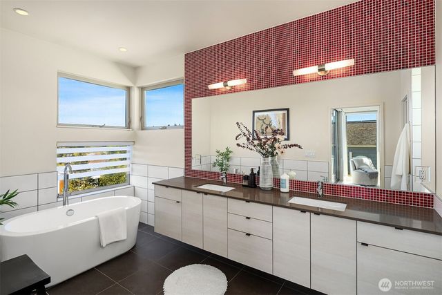 a bathroom with a bathtub and shower