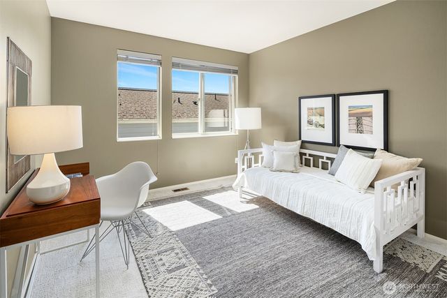 a bedroom with a bed and a wall painting