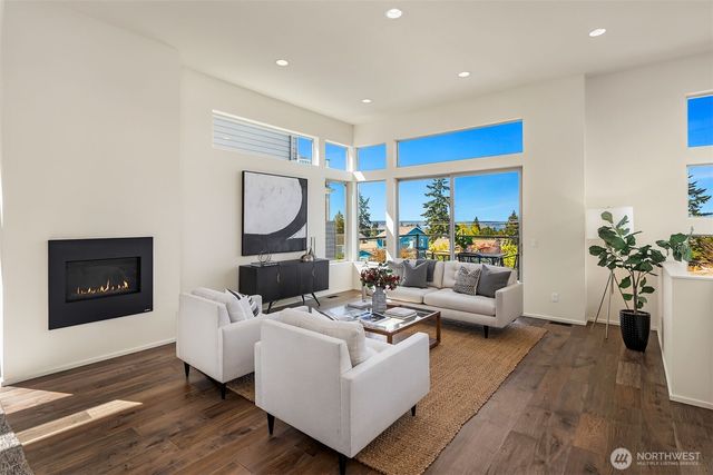 a living room with furniture mirror and a potted plant
