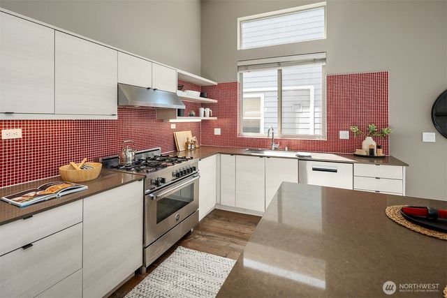 a kitchen that has a sink and a stove
