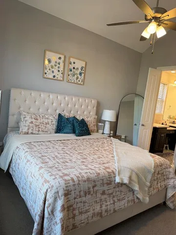 a bedroom with a bed dresser and a window