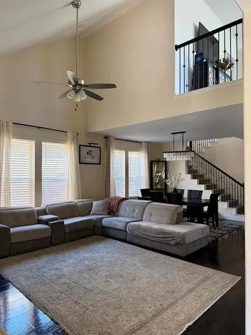 a living room with furniture fireplace and a window