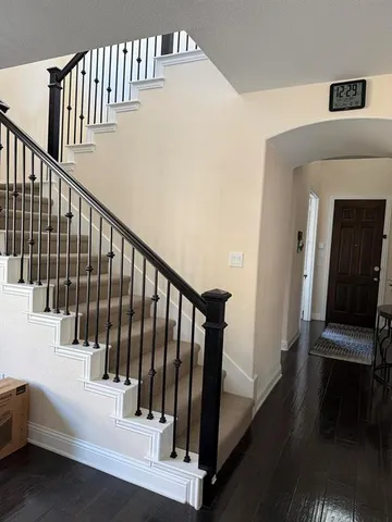 a view of staircase with railing and a rug