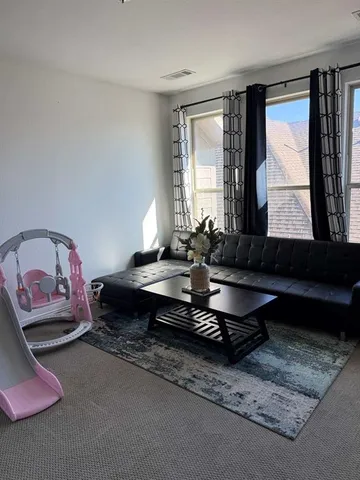 a living room with hard wood floor and furniture