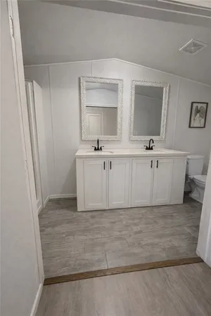 a bathroom with a sink a mirror and a bathtub