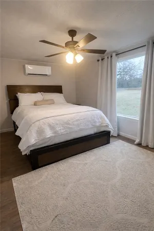 a large bed sitting in a bedroom next to a window