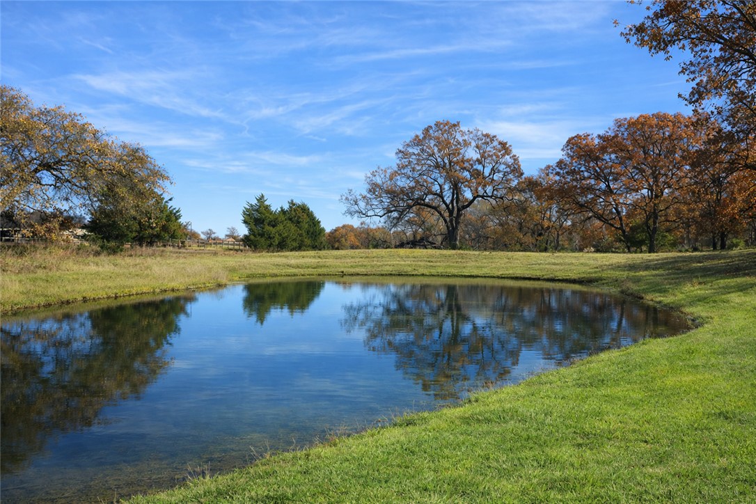 7031 Red Rock Road Franklin, TX 77856 - Photo 4 of 17 a view of a lake with a big yard