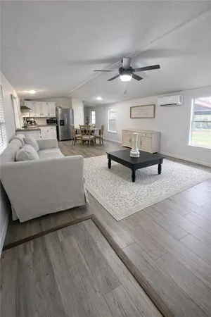 a living room with furniture and a wooden floor