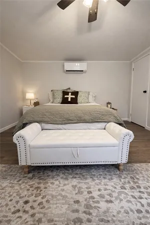 a spacious bedroom with a bed and a dresser