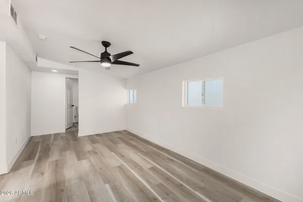 a view of empty room with ceiling fan