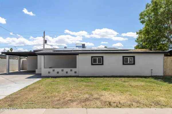 a backyard of a house with yard and outdoor seating