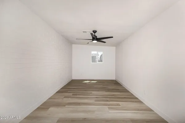 a view of a room with wooden floor