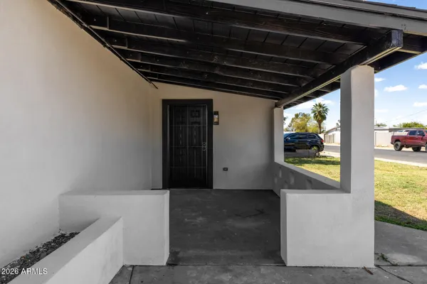 a view of empty room with wooden floor and ceiling fan