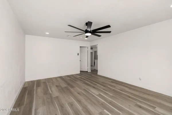 a kitchen with a refrigerator and white cabinets