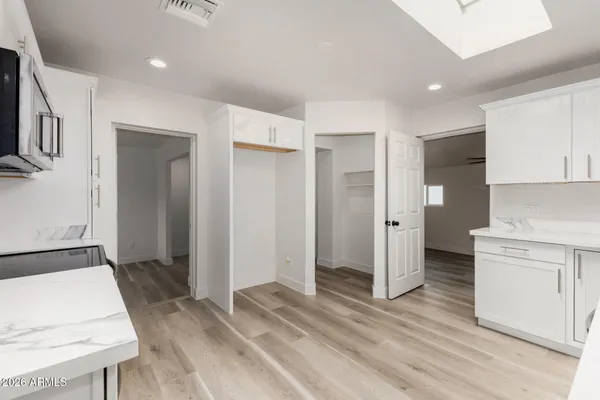 a kitchen with stainless steel appliances a stove microwave and sink