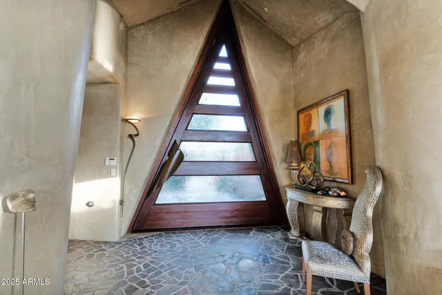 a backyard of a house with table and chairs