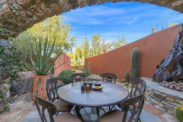 a view of a patio with couches table and chairs and potted plants