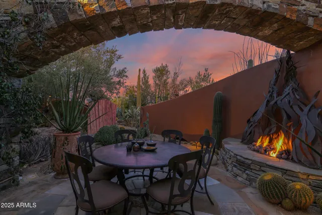 a view of a patio with a table and chairs and potted plants