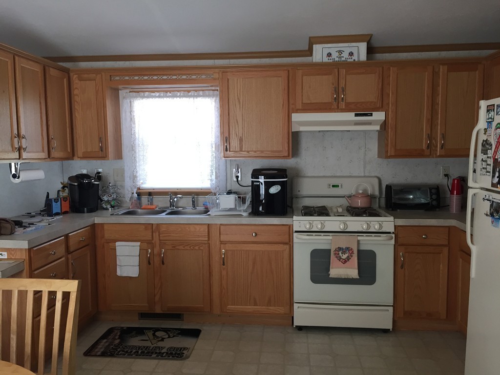557-122 Southwest Cutoff Worcester, MA 01607 - Photo 4 of 12 a kitchen with a white stove top oven and sink