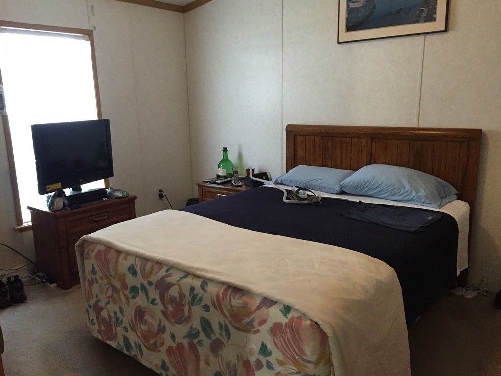 557-122 Southwest Cutoff Worcester, MA 01607 - Photo 5 of 12 a bedroom with a bed and a flat tv screen on a dresser
