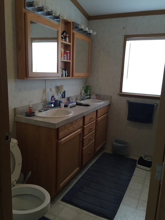 557-122 Southwest Cutoff Worcester, MA 01607 - Photo 8 of 12 a bathroom with a toilet sink and mirror