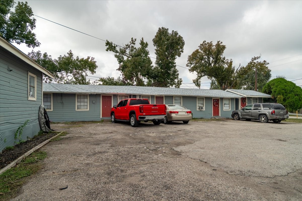 13928 Bandera Street Houston, TX 77015 - Photo 26 of 40 A clear look at the parking area positioned directly in front of a row of units, offering convenient walk-up access for residents and a simple, functional layout.
