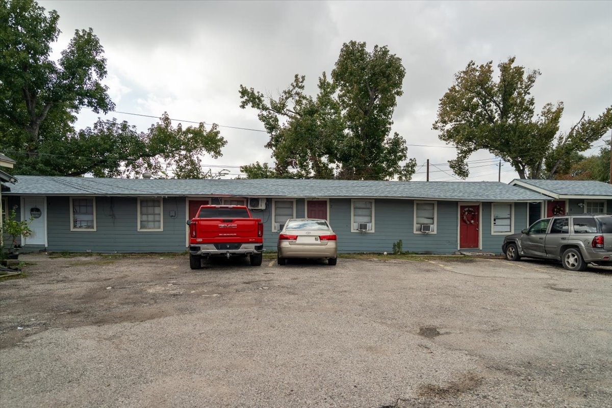 13928 Bandera Street Houston, TX 77015 - Photo 27 of 40 A wider angle that highlights the connected units along the courtyard, with easy parking directly in front and mature trees providing a natural backdrop.