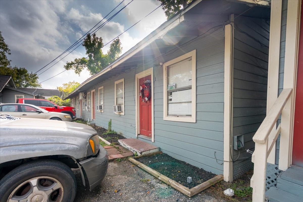 13928 Bandera Street Houston, TX 77015 - Photo 29 of 40 Unit 1 features a welcoming doorstep with direct access from the parking area. A row of neighboring units sits alongside it, each with easy, ground-level entry.