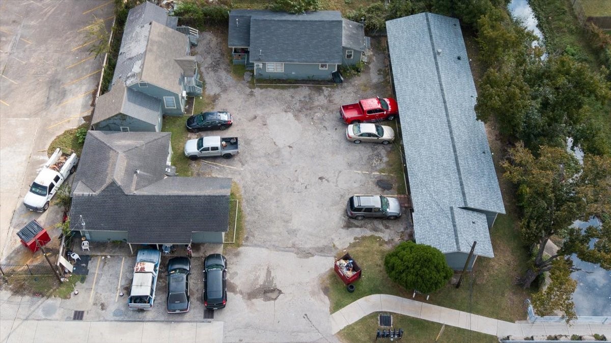 13928 Bandera Street Houston, TX 77015 - Photo 31 of 40 An overhead view reveals the arrangement of buildings surrounding the central courtyard, along with the open parking area and accessible driveways connecting each unit.