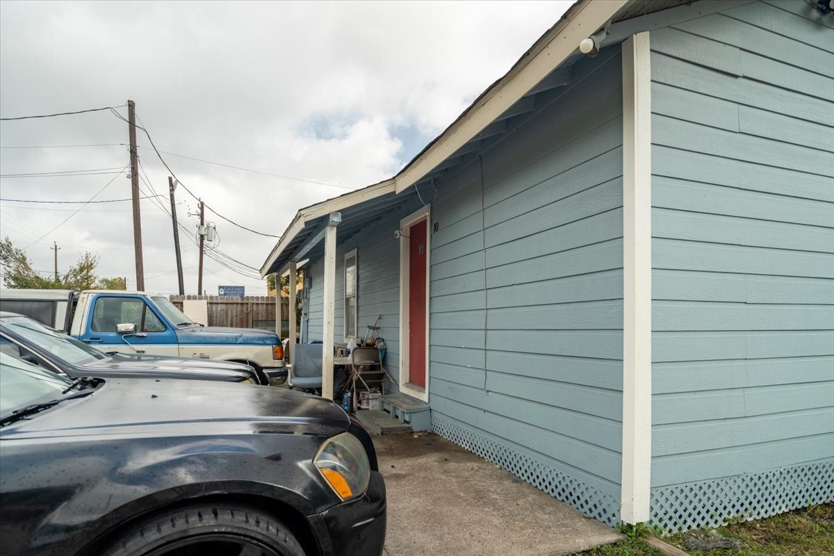 13928 Bandera Street Houston, TX 77015 - Photo 5 of 40 This vantage point showcases a welcoming unit entrance with a covered porch and direct parking just steps away. The clean exterior and easy access make this a practical setup for tenants and a strong feature for long-term occupancy appeal.