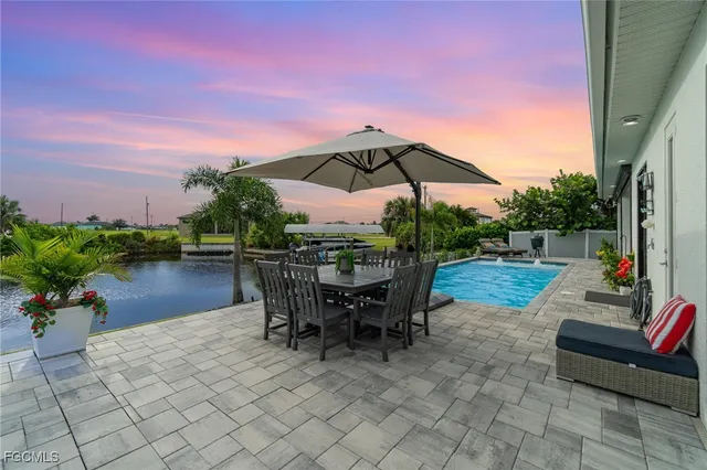a backyard of a house with table and chairs