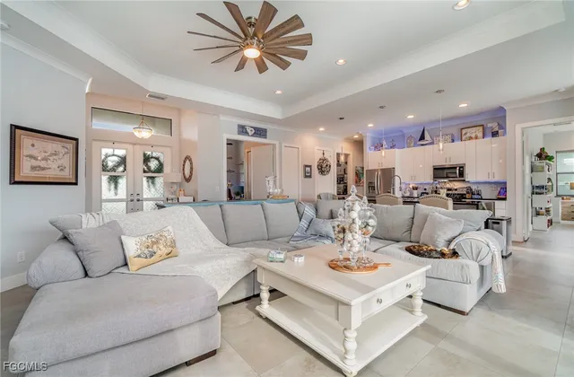 a kitchen with stainless steel appliances kitchen island granite countertop a table chairs and a refrigerator