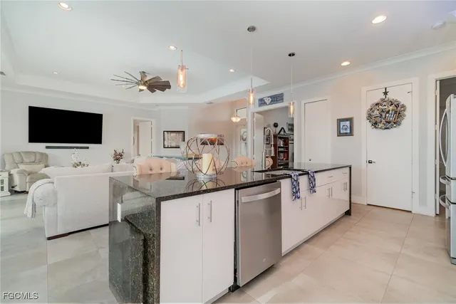 a kitchen with stainless steel appliances granite countertop a refrigerator and a stove top oven